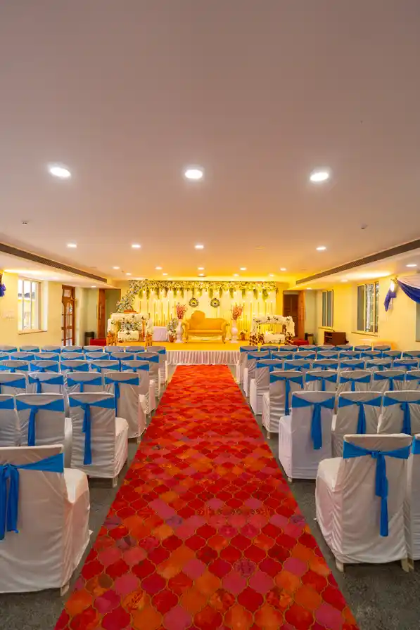 The hall in theatre seating, looking towards the lit gold stage