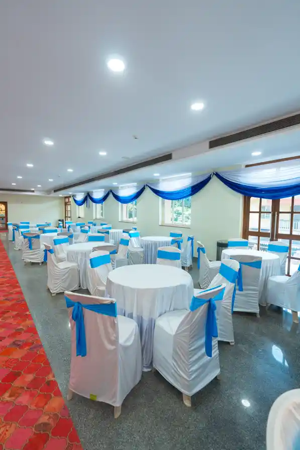 The same round-table layout seen down the length of the hall