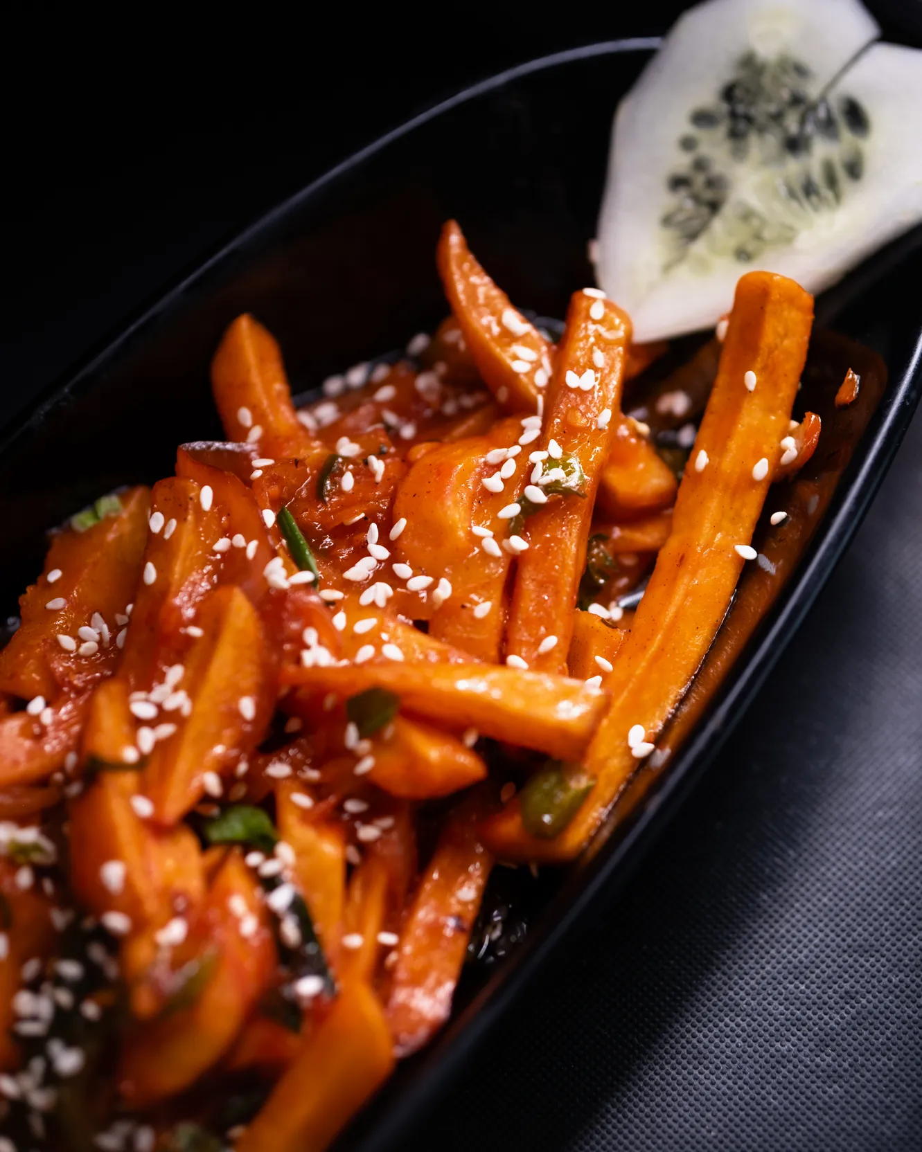 Honey chilli carrots scattered with sesame seeds