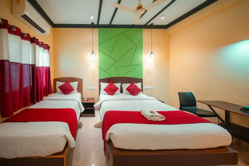 A Deluxe Twin room with towels folded on the beds